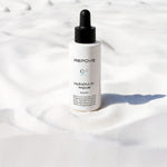 Flacon REPOVE HydroDNA 95 Ampoule posé sur du sable blanc